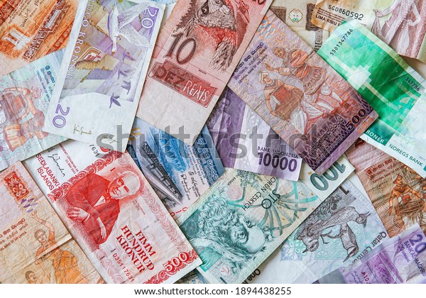 different banknotes from all over the world.
all countries are suffering from the financial crisis. close up of
cash from many different
countries.