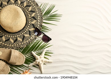 Different Beach Accessories On Sand, Flat Lay. Space For Text