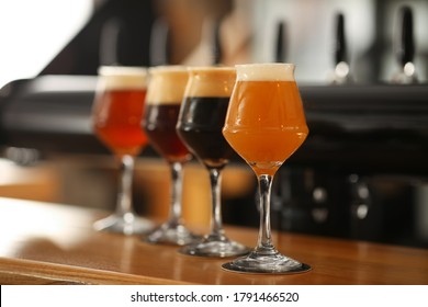 Different Beers In Glasses On Bar Counter