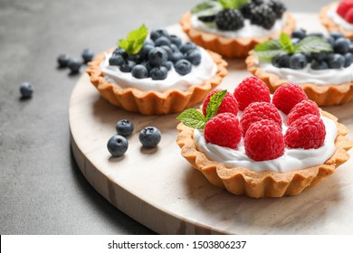 Different berry tarts on light table. Delicious pastries - Shutterstock ID 1503806237