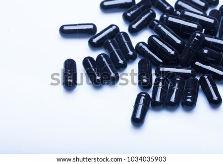 A lot of different black tablets on white table. Medecine theme