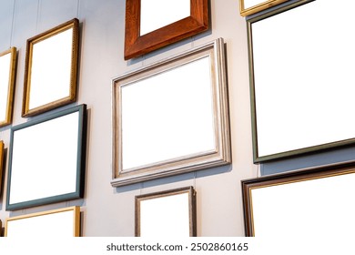 Different blank empty cut out frames paintings photos pictures on a gallery art museum wall, copy space template mockup, art exhibition concept, nobody, angle, generic. Works of art hanging on a wall
