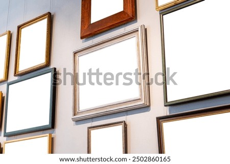 Different blank empty cut out frames paintings photos pictures on a gallery art museum wall, copy space template mockup, art exhibition concept, nobody, angle, generic. Works of art hanging on a wall