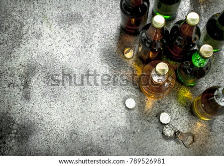 Different bottles of beer. On a rustic background.