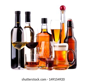 Different Bottles And Glasses Of Alcoholic Drinks Isolated On A White Background