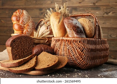 Different bread with ears in basket on wooden background - Powered by Shutterstock