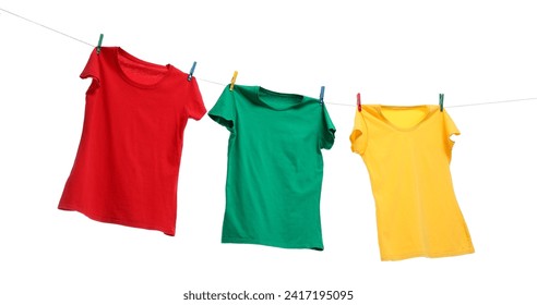 Different bright t-shirts drying on washing line against white background - Powered by Shutterstock