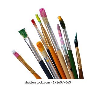 Different brushes with paints on white background
