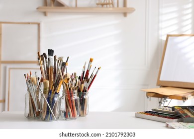 Different brushes, paints and palette on white table indoors, space for text. Artist's workplace - Powered by Shutterstock