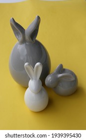 different ceramic easter bunnies isolated on colorful background