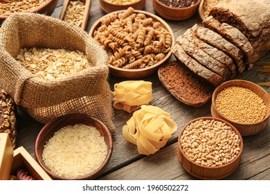 Different cereals, raw pasta and bread on wooden background, closeup - Shutterstock ID 1960502272
