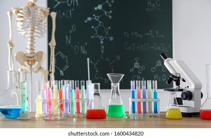 Different Chemistry Glassware On Table In Classroom