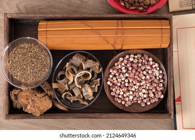 Different Chinese Medicinal Materials And A Roll Of Bamboo Slips In A Wooden Box