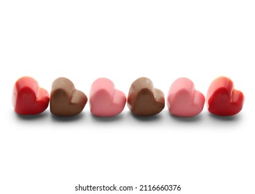 Different Chocolate Candies In Shape Of Hearts On White Background