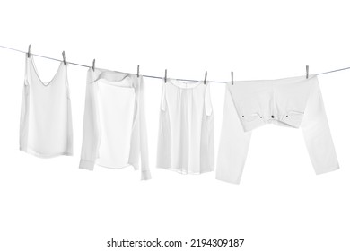 Different clothes drying on laundry line against white background