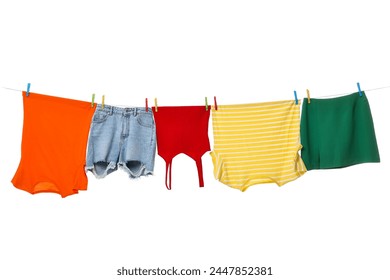 Different clothes drying on laundry line against white background