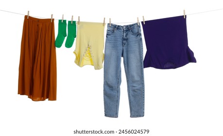 Different clothes drying on laundry line against white background