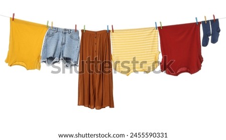 Different clothes drying on laundry line against white background