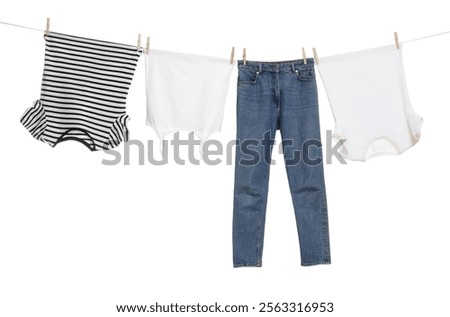 Different clothes drying on laundry line against white background
