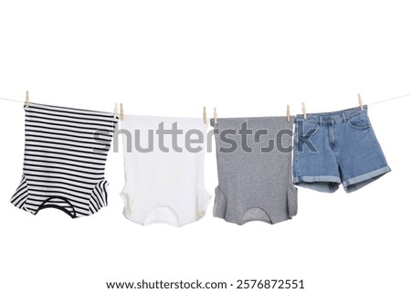 Different clothes drying on laundry line against white background