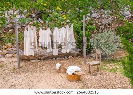 Different clothes drying on laundry line against garden background,clothes hanging laundry on washing line for drying towels drying on the clothesline.