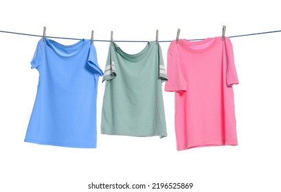 Different clothes drying on washing line against white background