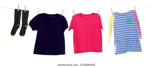 Different clothes drying while hanging on clothesline against white background