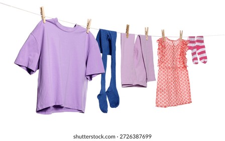 Different clothes drying while hanging on clothesline against white background