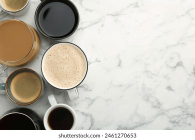 Different coffee drinks in cups on white marble table, flat lay. Space for text