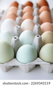 Lot of different color chicken eggs arranged by color on paper egg box. All sorts of colors: blue, green, white, beige, brown. From natural organic farm. Minimal above view. - Shutterstock ID 2269343119