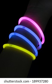 Different Color Glow Stick Bracelets On Hand