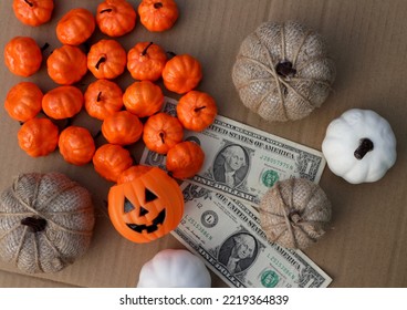 Different Color Of Pumpkin Decorating With Dollar Money On Wood Table