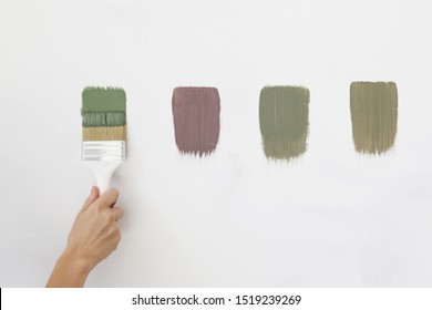 A Different Color Swatches On The White Wall. 
Process Of Choosing The Right Color For The Wall, DIY Home Improvement Concept. 