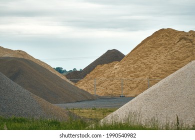 Different Colored Hills Of Sand, Gravel, Cement And Building Materials Under Blue Sky. Illustration Of Building Industry, Construction Sector Or Mining. Color Photo.                     