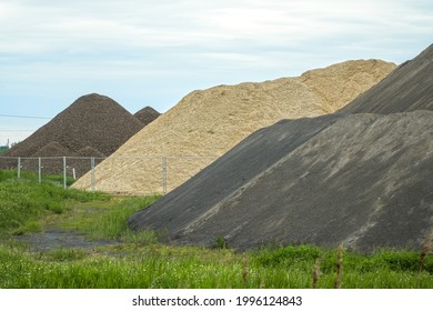 Different Colored Hills Of Sand, Gravel, Cement And Building Materials Under The Blue Sky. Illustration Of Building Industry, Construction Sector Or Mining. Color Photo.       