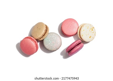 Different colorful French macarons isolated on white background. Culinary and cooking concept. Tasty baked food, assorted confectionery range, top view