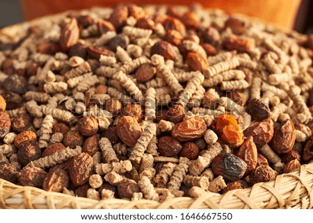 Similar – Dried poppy seed capsules on an old metal plate