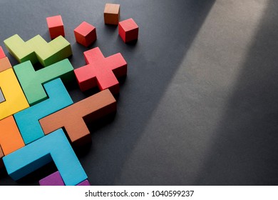 Different colorful shapes wooden blocks on black background, flat lay. Geometric shapes in different colors, top view. Concept of creative, logical thinking or problem solving. Copy space. - Shutterstock ID 1040599237