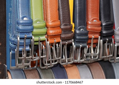 different colors leather belt on display at the market for sale