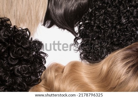 The different colour and texture hair blond, brown, black straight and curly isolated on the white background