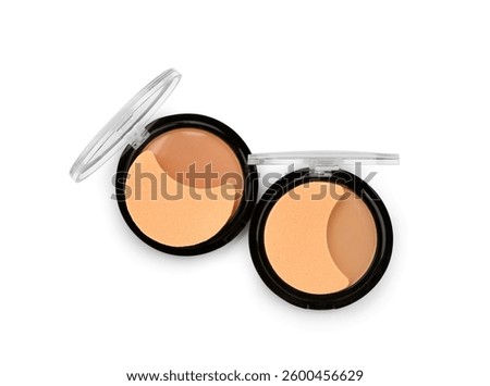 Different compact powder with sponge on white background