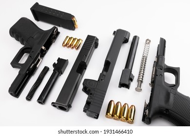 Different components between of the .45 and 9mm semi automatic handgun on white background