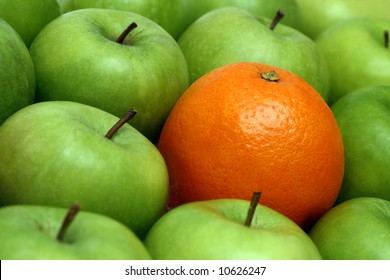different concepts - orange between green apples