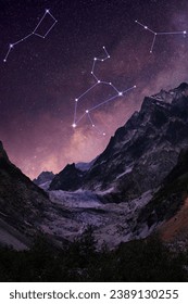 Different constellations in starry sky over mountains at night