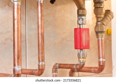 Different Copper Pipes And Accessories On The Wall