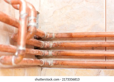 Different Copper Pipes On The Wall