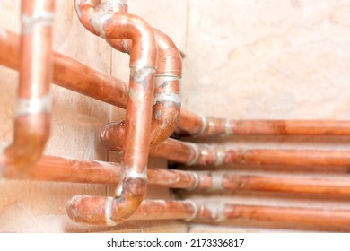 Different Copper Pipes On The Wall