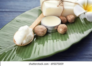 Different cosmetic products with shea butter on plate, closeup