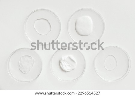 Different Cosmetics Products Samples of Gel in Laboratory Petri Dishes on white background