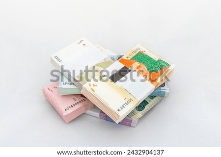 Different denominations of Pakistani banknotes bundles on white isolated background